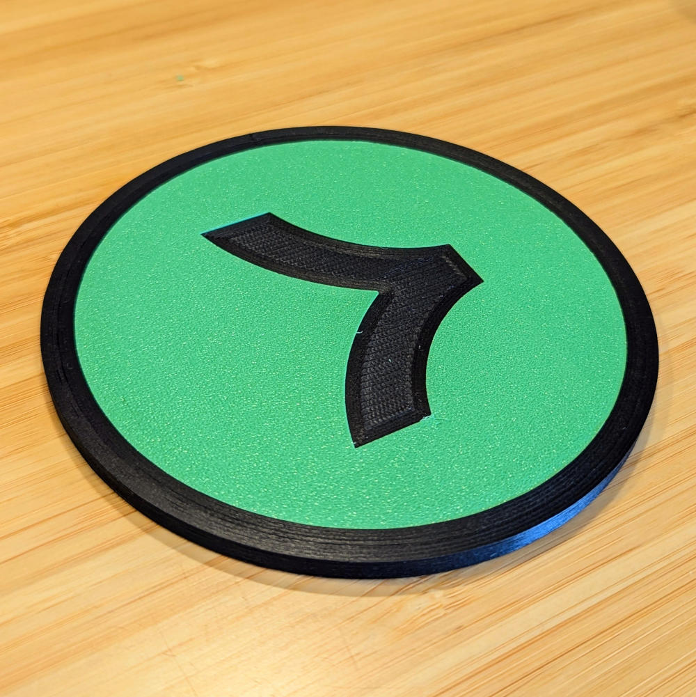 A drink coaster with the Stripe Link logo embedded in it