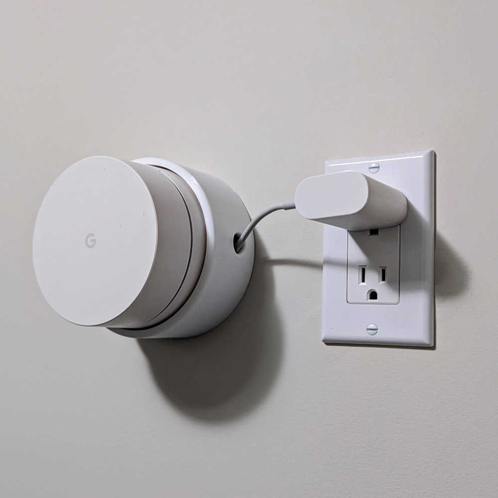 A wall-mounted Google WiFi puck