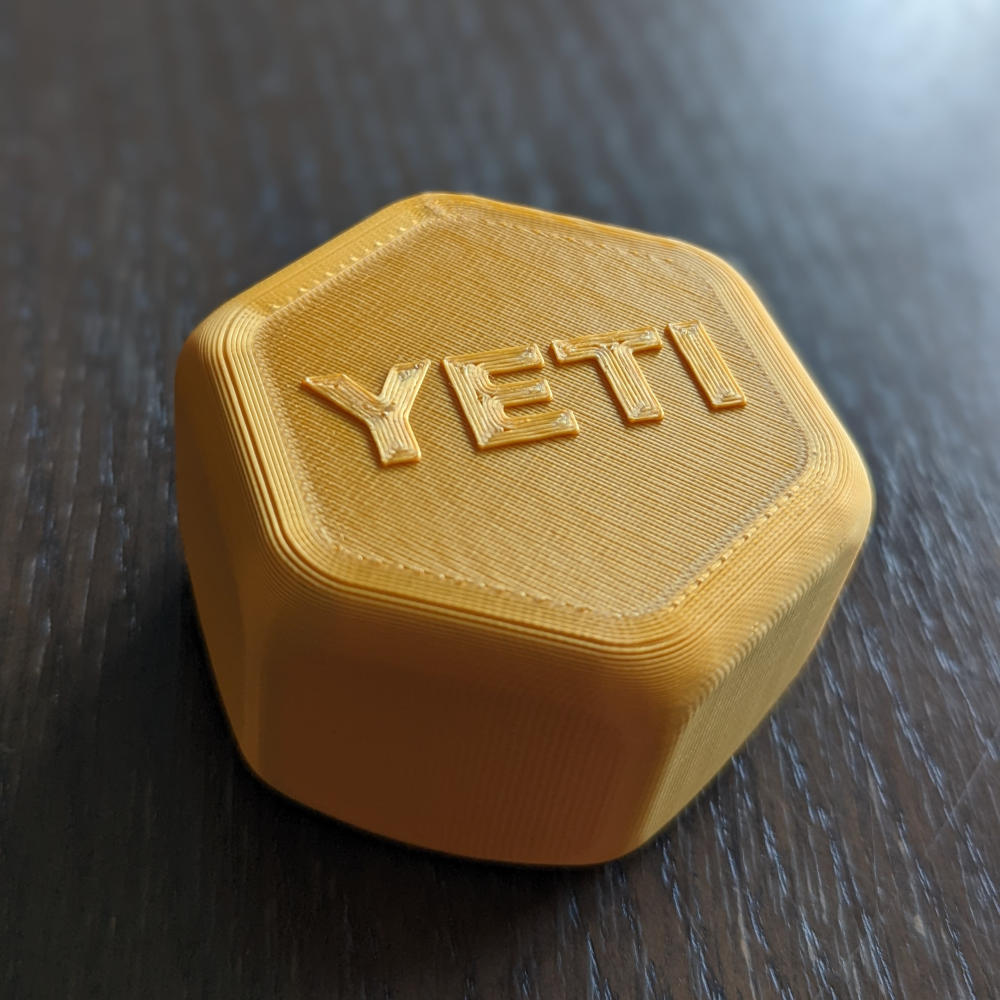 A hexagonal spacer with the words 'YETI' on it